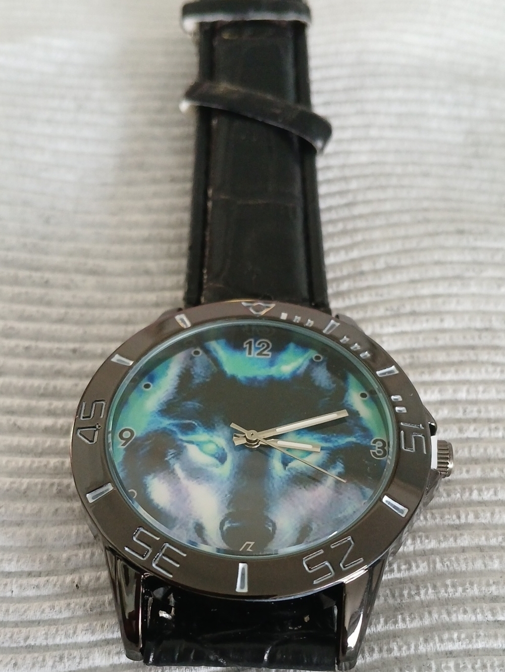 Black Strap Wristwatch with Blue-Green Wolf Face Dial